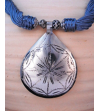 Detail of ethnic chic tribal style teardrop pendant Nomad necklace hand made from from silver metal & sabra silk in grey blue