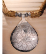 Detail of ethnic chic tribal style teardrop pendant Nomad necklace hand made from from silver metal & sabra silk in beige