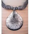 Detail of ethnic chic tribal style teardrop pendant Nomad necklace hand made from from silver metal & sabra silk in taupe