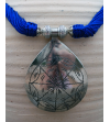 Detail of ethnic chic tribal style teardrop pendant Nomad necklace hand made from from silver metal & sabra silk in Royal Blue