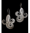 Close up of Peruvian Filigree "Wave" chandelier earrings handmade in 925 natural and oxidised silver on a black background