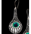 Detail of filigree "Peacock" drop earrings handmade from 925 silver on a black background