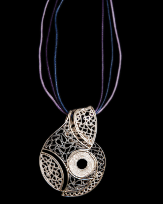 Artisan made filigree "Lucía" pendant necklace handmade in 925 oxidiised and natural silver on a black backdrop