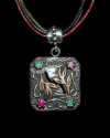 Small Byzantine style square silver pendant with emerald stones and ruby gems