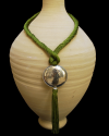 Artisan made ethnic chic art déco pendant necklace made from sabra silk in anise green and a hammered silver sphere with tassel