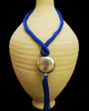 Artisan made ethnic chic art déco pendant necklace made from sabra silk in royal blue and a hammered silver sphere with tassel