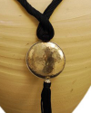 Detail of art déco pendant necklace in black and a hammered silver sphere with hanging tassel