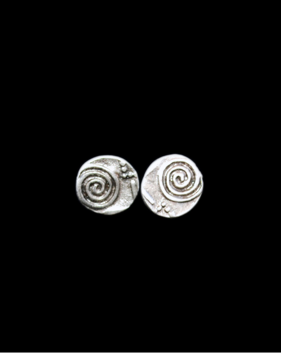 Front view of Andaluchic´s "Universe" motif stud earrings made in oxidised silver plated zamak on a black background