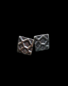 Front view of Andaluchic´s "Geometric" Stud earrings in oxidised silver plated zamak on a black backdrop