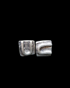 Front view of Andaluchic´s "U" motif stud earrings turned on it´s side made in oxidised silver plated zamak on a black backdrop
