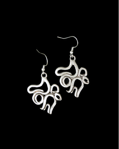 Front view of Andaluchic´s "Calligraphy" motif drop earrings in oxidised silver plated zamak displayed on a black backdrop