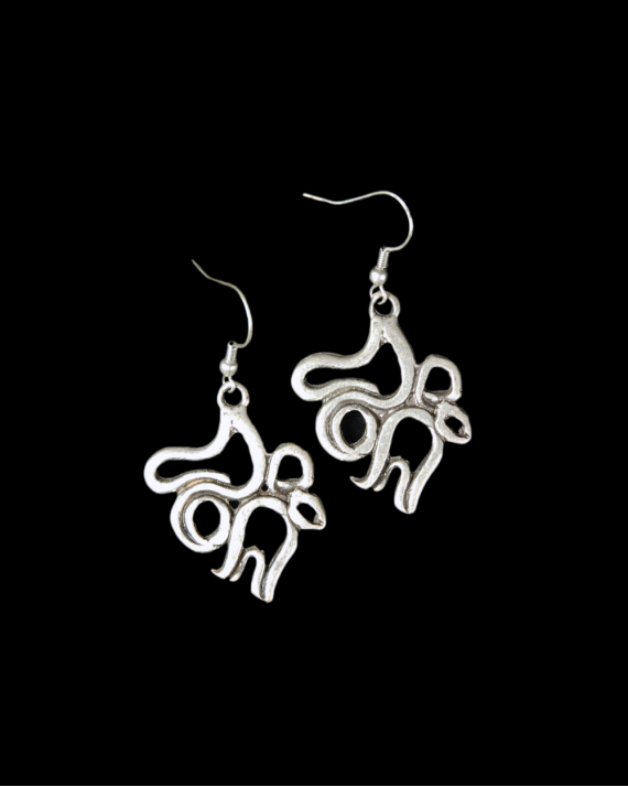 Front view of Andaluchic´s "Calligraphy" motif drop earrings in oxidised silver plated zamak displayed on a black backdrop