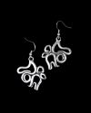 Front & back view of Andaluchic´s "Calligraphy" motif drop earrings in oxidised silver plated zamak displayed on black backdrop
