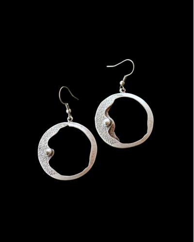 Front view of Andaluchic´s "Clair de Lune" moon drop earrings made from oxidised silver plated zamak on a black background