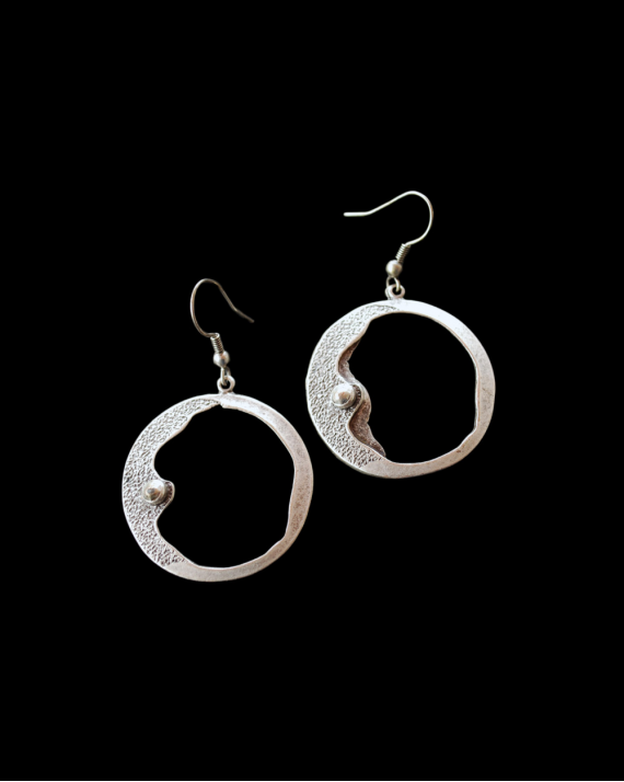 Front view of Andaluchic´s "Clair de Lune" moon drop earrings made from oxidised silver plated zamak on a black background