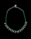 View of Andaluchic´s delicate "Crete" Necklace in antiqued silver plated zamak strung with green beads on a black backdrop