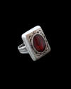 Angled front view of Andaluchic´s adjustable "Signet" ring in anitqued silver plated zamak inserted with red resin