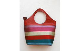 Red leather tote bag in striped fabric in pink, cream, red, turquoise and blue