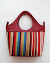 Red handbag in goatskin leather with vertical multicolored striped fabric