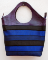 Large purple leather tote bag with striped fabric in royal blue and black