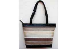 Large black leather shoulder bag with white, cream and brown striped fabric