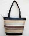 Large brown leather shoulder bag with striped fabric in white, cream and beige