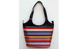 Large black leather shoulder bag with bright striped handwoven textile