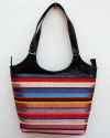 Large black leather shoulder bag with bright striped handwoven textile