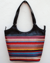 Large black leather shoulder bag with bright striped handwoven textile