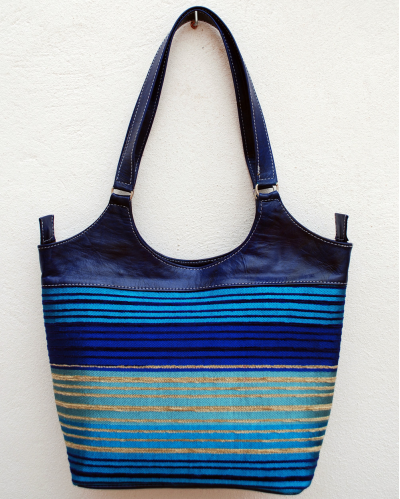 Large blue leather shoulder bag with blue, turquoise, purple and gold striped fabric