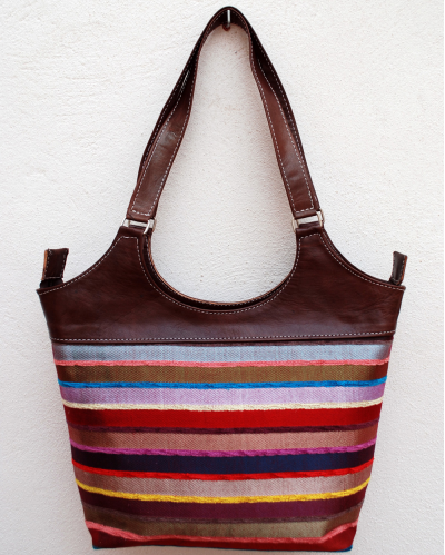 Large dark brown leather shoulder bag with multicolored striped fabric