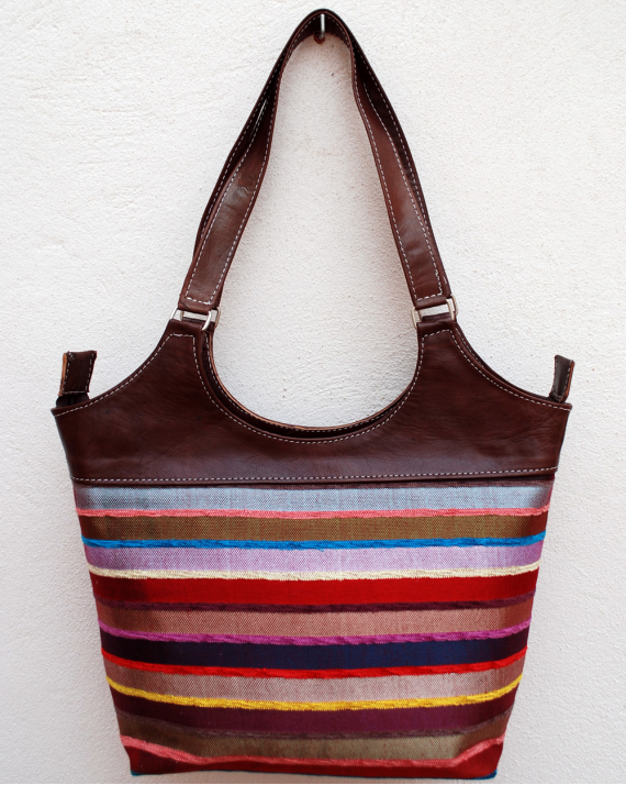 Large dark brown leather shoulder bag with multicolored striped fabric