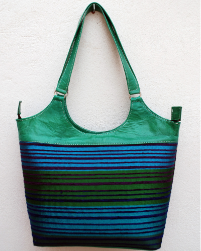 Large green leather shoulder bag with multicolored striped fabric