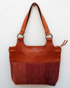 Back view of Andaluchic´s "Anillas" shoulder bag up-cycled in hand-woven cotton in reds & terracota combined with tan leather