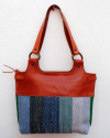 Back view of Andaluchic´s "Anillas" shoulder bag hand-woven in up-cycled cotton in blue & turquoise tones with tan leather