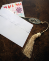 Hand engraved letter opener with tassel in jewel colors