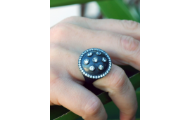 Oxidized silver cocktail ring with round shield design and zirconia