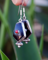 Oblong point drop earrings made in sterling silver inset with semi-precious stones of black onyx with small central red coral