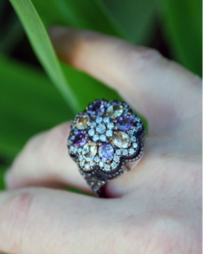 Top view of stunning Flower Cocktail Ring made in oxidised 925 silver with clear, violet and apricot coloured zircons