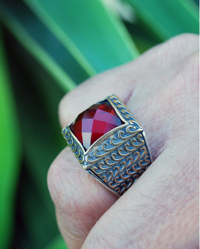 Square shaped chunky Byzantine style ring inset with a deep red diamond cut zircon in 925 silver with a golden patterned overlay