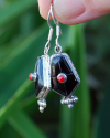 Oblong point drop earrings made in sterling silver inset with semi-precious stones of black onyx with small central red coral