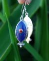 Long Oval drop earrings hand made in silver inset with semi-precious stones of lapis lazuli with a small central red coral
