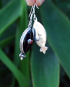Long Oval drop earrings hand made in silver inset with semi-precious stones of black onyx with a small central red coral