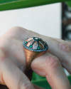 Gold leaf Line Shield Cocktail Ring in a Byzantine style inserted with green zircons surrounded by transparent zircons