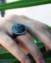 Vintage Style Round Shield Ring in oxidised silver with central & surrounding green zircons bordered by small clear zircons
