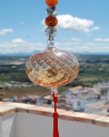 Blown glass sphere with tassel: oriental talisman, witchball, suncatcher