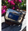 Brown wide belt with large rectangular belt buckle and a blue resin inset